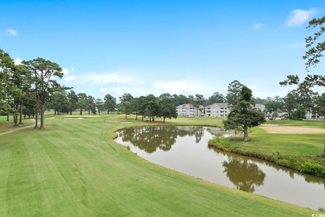 view of community featuring a lawn and a water view