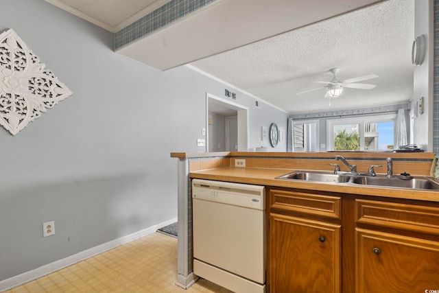 kitchen with white dishwasher, ceiling fan, crown molding, and sink