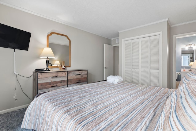 carpeted bedroom featuring a textured ceiling, a closet, and ornamental molding