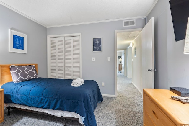 bedroom featuring a textured ceiling, light colored carpet, a closet, and ornamental molding