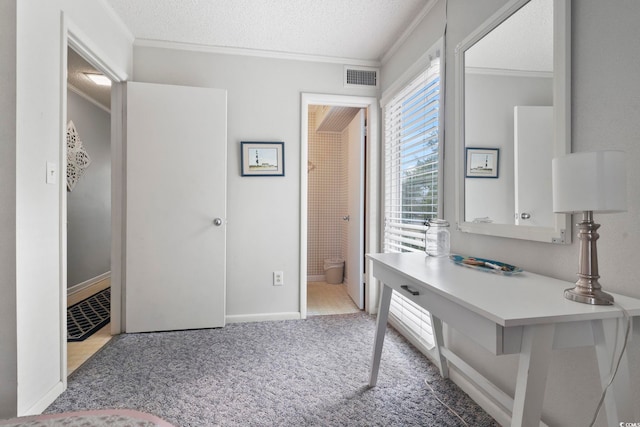 office with a textured ceiling, ornamental molding, and light carpet