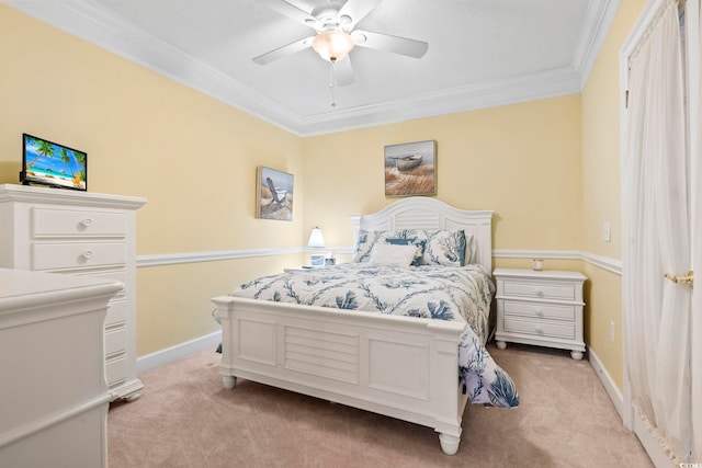 carpeted bedroom featuring ceiling fan and crown molding