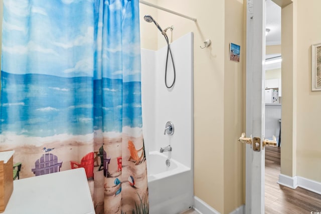 bathroom featuring shower / bath combo with shower curtain and hardwood / wood-style flooring