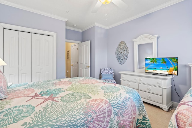 carpeted bedroom featuring a closet, ceiling fan, and crown molding