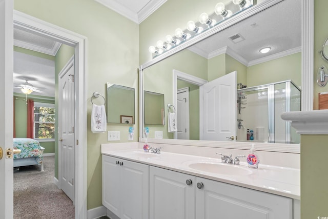 bathroom with ceiling fan, an enclosed shower, a textured ceiling, and ornamental molding