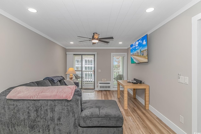 living room with ceiling fan, wood-type flooring, crown molding, and an AC wall unit