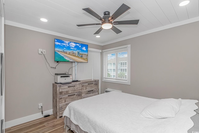 bedroom featuring light wood-type flooring, ceiling fan, and crown molding