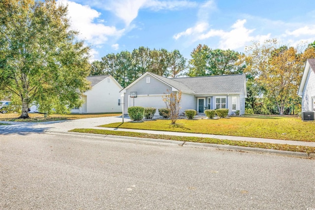 ranch-style house featuring cooling unit, a front lawn, and a garage