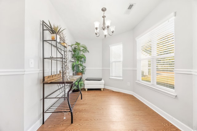 living area featuring hardwood / wood-style floors and a notable chandelier