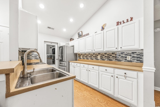 kitchen featuring backsplash and white cabinetry