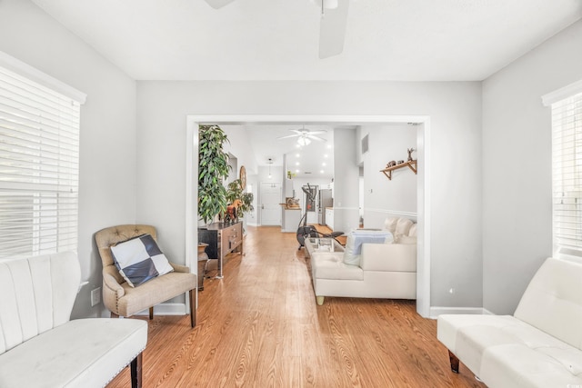 sitting room with light hardwood / wood-style flooring and ceiling fan