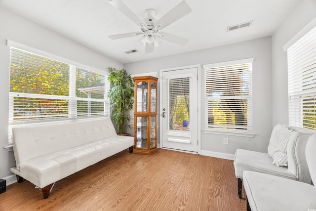 living area featuring ceiling fan, a healthy amount of sunlight, and light wood-type flooring