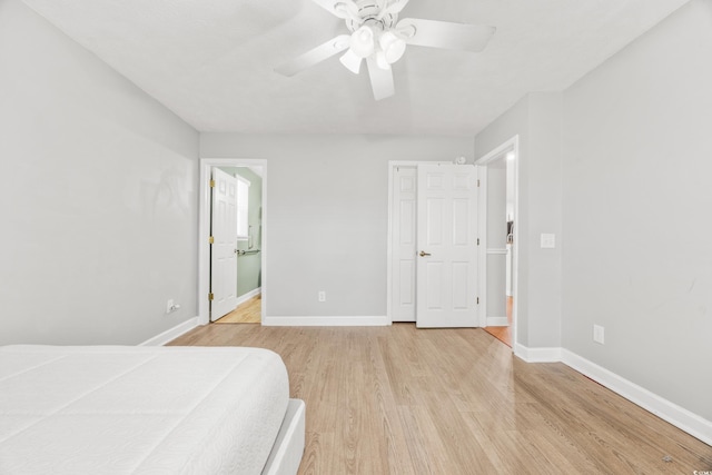 bedroom with ceiling fan, ensuite bathroom, and light hardwood / wood-style flooring