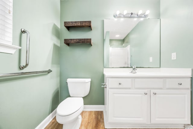 bathroom featuring hardwood / wood-style floors, vanity, and toilet