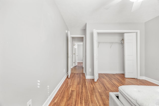 unfurnished bedroom featuring a closet, hardwood / wood-style flooring, and ceiling fan