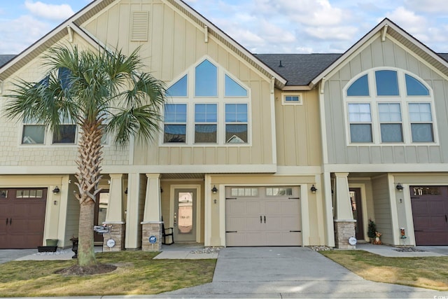 view of front of house featuring driveway, a shingled roof, board and batten siding, and an attached garage