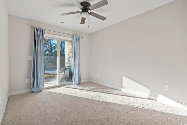 carpeted empty room with a ceiling fan, visible vents, and baseboards