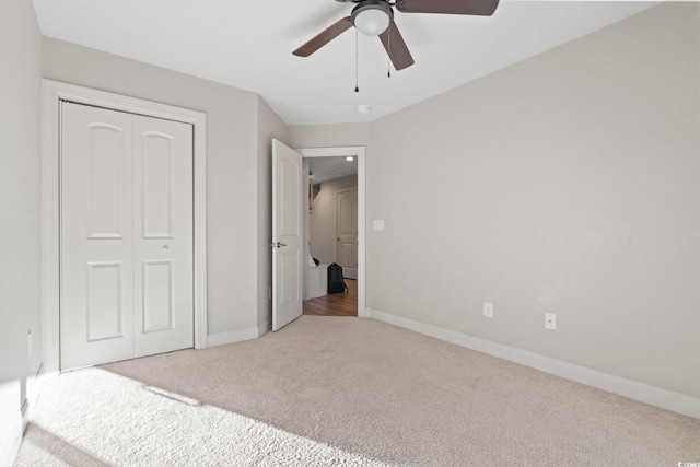 unfurnished bedroom featuring a closet, carpet flooring, ceiling fan, and baseboards