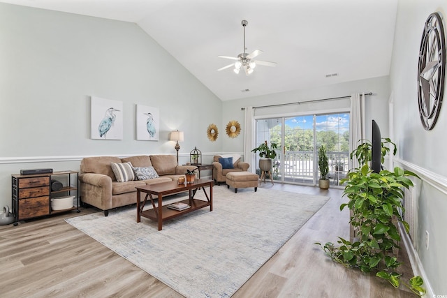 living room featuring ceiling fan, light wood-type flooring, and high vaulted ceiling