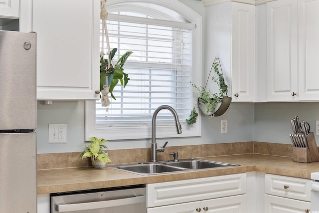 kitchen featuring white cabinetry, sink, and appliances with stainless steel finishes