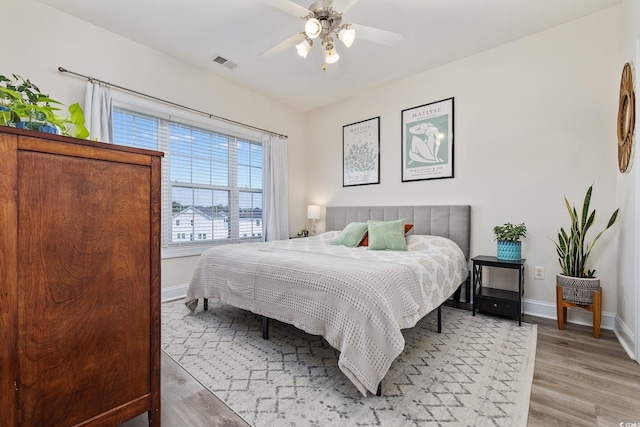 bedroom with ceiling fan and light hardwood / wood-style flooring