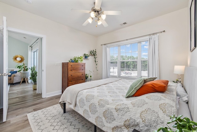 bedroom with ceiling fan and light hardwood / wood-style flooring