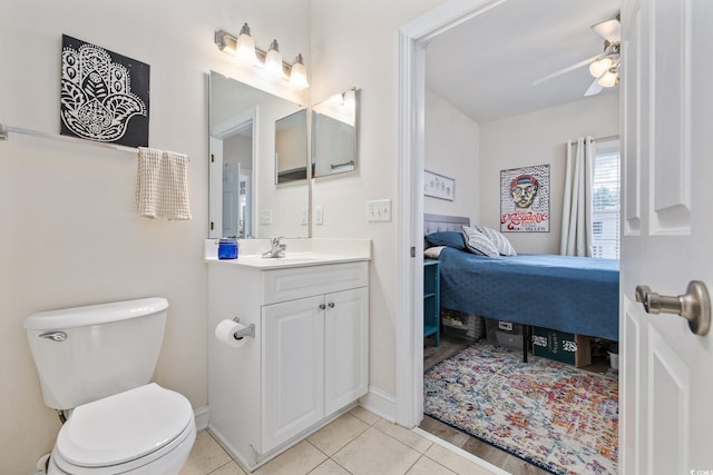 bathroom with tile patterned flooring, ceiling fan, toilet, and vanity