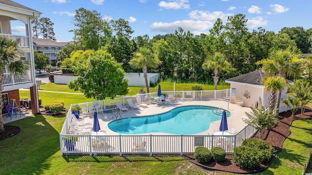 view of pool featuring a yard and a patio