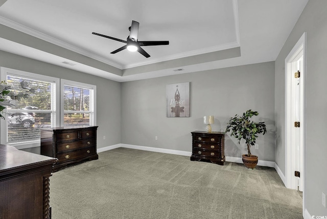 interior space featuring a tray ceiling, crown molding, ceiling fan, and light colored carpet