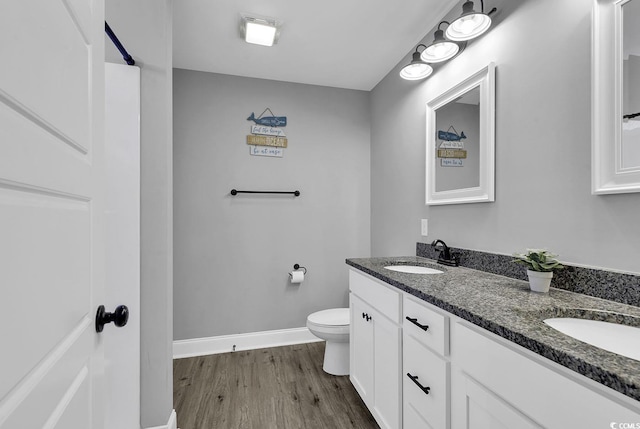 bathroom with hardwood / wood-style flooring, vanity, and toilet