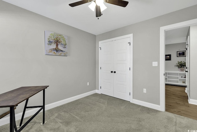 carpeted bedroom with ceiling fan and a closet