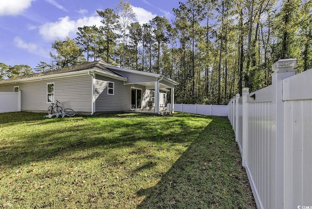 rear view of property with a lawn