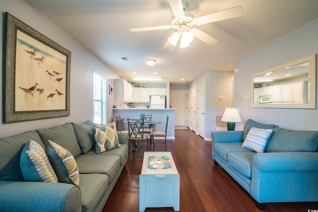 living room with ceiling fan and dark hardwood / wood-style floors