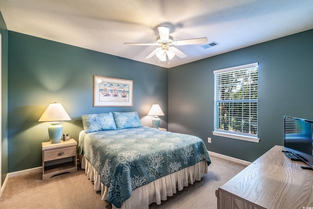 bedroom featuring light colored carpet and ceiling fan