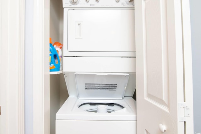 laundry area featuring stacked washer / drying machine