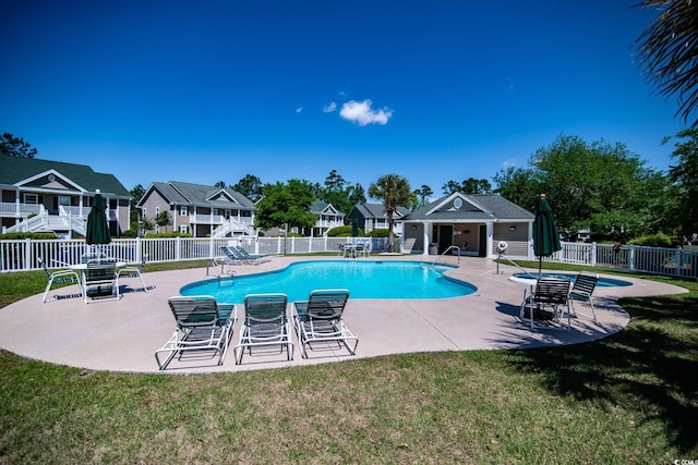 view of pool featuring a patio, an outdoor structure, and a lawn