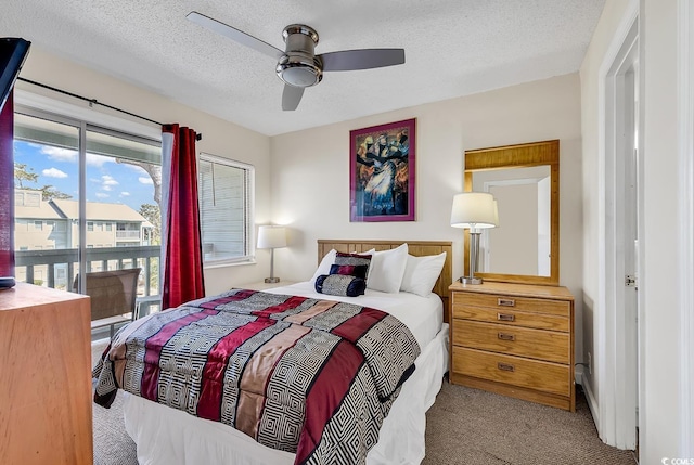 carpeted bedroom featuring a textured ceiling and ceiling fan