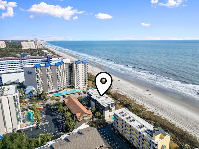 drone / aerial view featuring a water view and a beach view