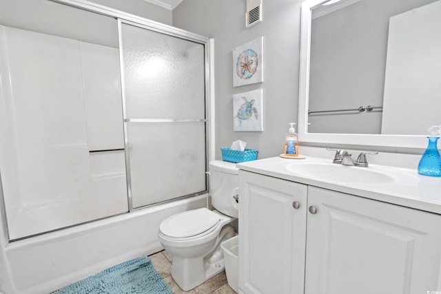 full bathroom featuring tile patterned floors, vanity, toilet, and bath / shower combo with glass door