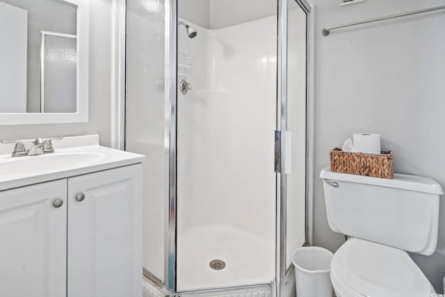 bathroom with vanity, an enclosed shower, and toilet