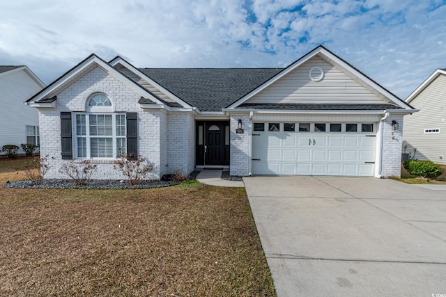 ranch-style home featuring a garage and a front lawn