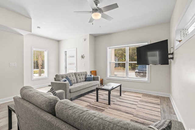 living room featuring light hardwood / wood-style floors and ceiling fan