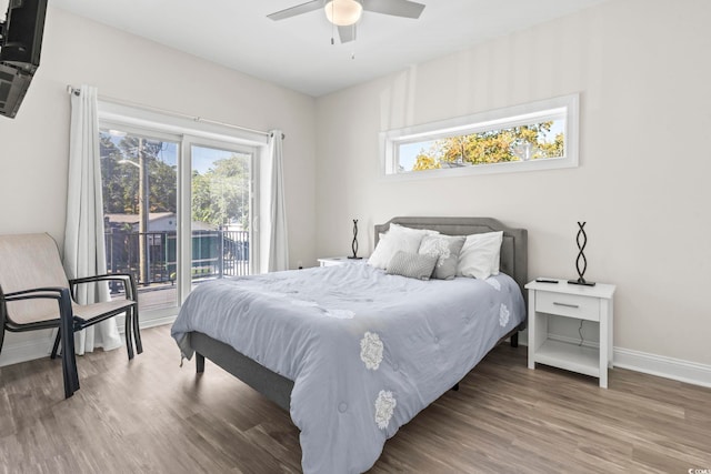 bedroom featuring hardwood / wood-style floors, ceiling fan, and access to outside