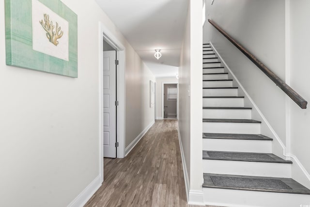 stairs featuring wood-type flooring