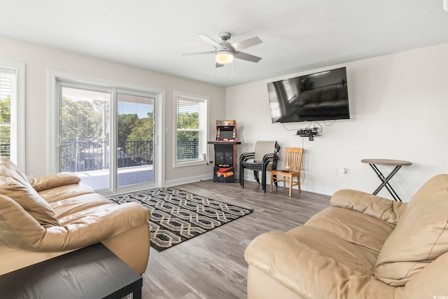 living room with hardwood / wood-style flooring and ceiling fan