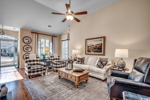 living room with wood-type flooring, vaulted ceiling, and ceiling fan