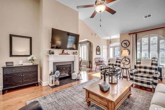 living room featuring ceiling fan, lofted ceiling, and hardwood / wood-style flooring