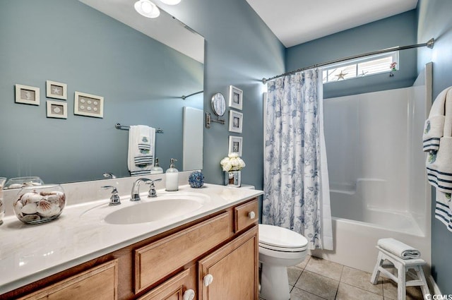 full bathroom with tile patterned floors, shower / bath combo with shower curtain, vanity, and toilet