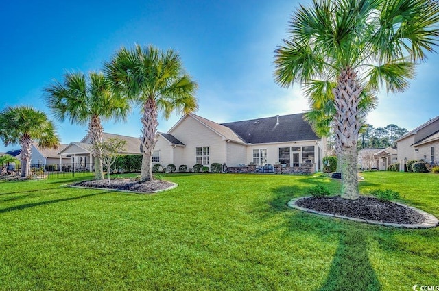 rear view of property with a lawn