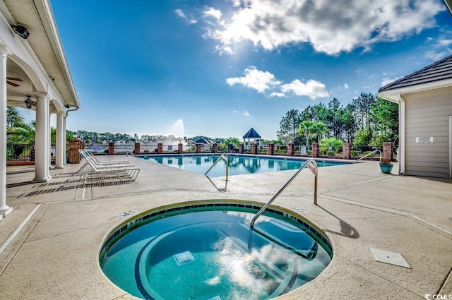 view of pool with a patio area and a community hot tub